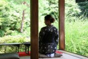 A woman sitting on a mat in a room