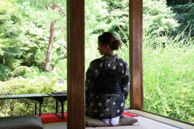 A woman sitting on a mat in a room