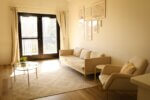 a living room filled with furniture and a window