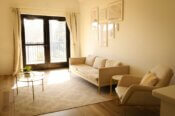 a living room filled with furniture and a window