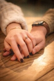 A close up of two people holding hands