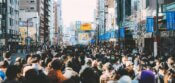 a large crowd of people walking down a city street