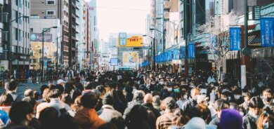 a large crowd of people walking down a city street